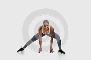 African American Woman Performing a Squat on White Background