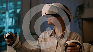 African American woman play virtual reality game at home night entertainment ethnic girl in VR helmet and modern device