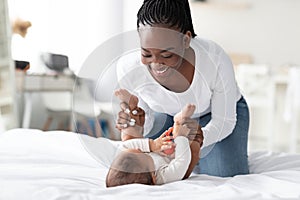 African American woman playing with her little baby