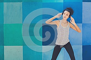 African-american woman posing at bright wall