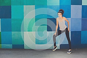 African-american woman posing at bright wall