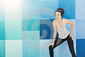 African-american woman posing at bright wall