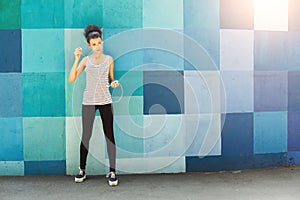 African-american woman posing at bright wall