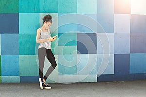 African-american woman posing at bright wall