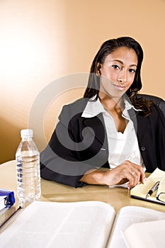 African-American woman reading and taking notes