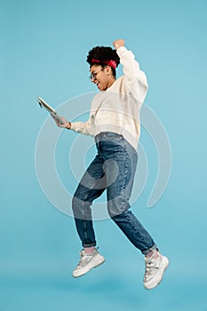 African-american woman& x27;s portrait isolated on blue studio background with copyspace