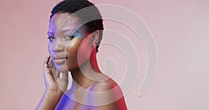 African american woman with short dark hair in blue and pink light with copy space, slow motion