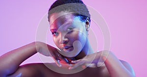 African american woman with short dark hair in blue and pink light with copy space, slow motion