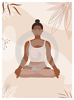 African American woman sits in lotus pose