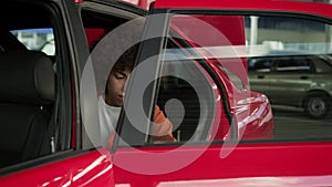 African American woman sitting at backseat in the taxi. Slow motion