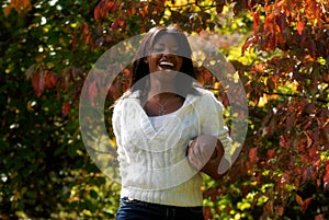 African-American woman smiles with a football