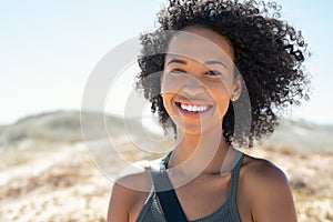 African american woman smiling at beach