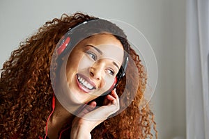 African american woman smiling and listening to music with headphones
