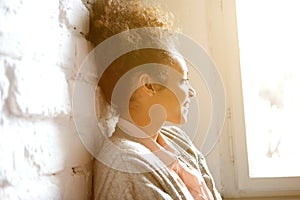 African american woman smiling and looking out of window