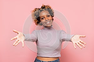 African american woman smiling with open arms for hug.