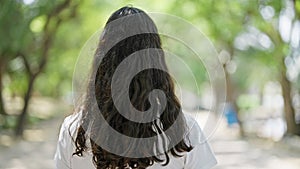 African american woman standing backwards at park