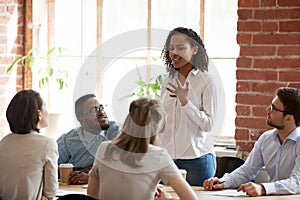 African American woman standing and talking at briefing