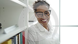 African american woman student smiling confident standing at library university