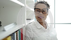 African american woman student smiling confident standing at library university