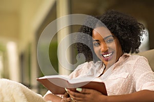 African American woman studing and reading the Bible.