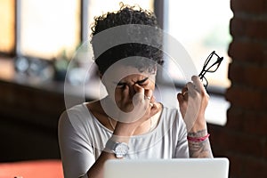 African American woman taking off glasses, feel eye strain