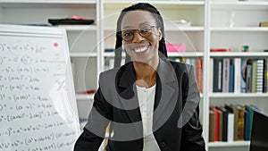 African american woman teacher smiling confident standing at university classroom