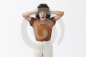 African American woman in trouble starting panic. Portrait of worried insecure and stunned girl with afro hairstyle
