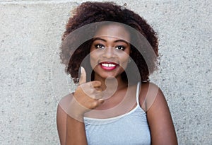 African american woman with typical afro hair showing thumb up