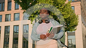 African American woman university college academy campus student teen girl high school schoolgirl with books schoolbag