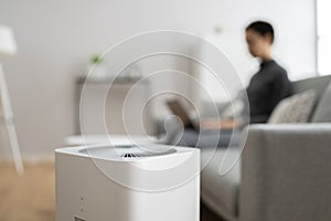 African American Woman Using Air Cleaner