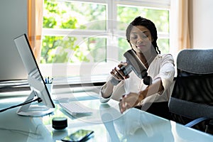 African American Woman Using Electric Massage Gun Machine