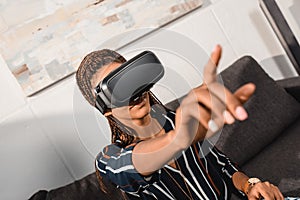 african american woman in vr headset pointing