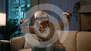 African American woman in VR helmet play virtual reality game happy amazed girl use controllers gaming simulation have