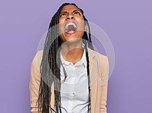 African american woman wearing business jacket angry and mad screaming frustrated and furious, shouting with anger