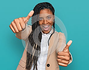 African american woman wearing business jacket approving doing positive gesture with hand, thumbs up smiling and happy for success