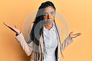 African american woman wearing business jacket clueless and confused with open arms, no idea and doubtful face