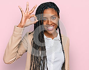 African american woman wearing business jacket smiling positive doing ok sign with hand and fingers