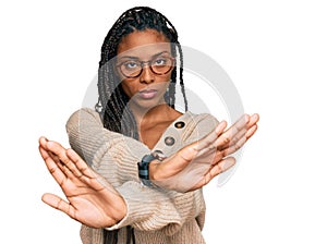 African american woman wearing casual clothes rejection expression crossing arms and palms doing negative sign, angry face