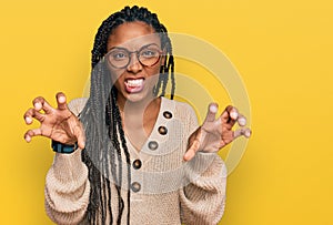 African american woman wearing casual clothes smiling funny doing claw gesture as cat, aggressive and sexy expression