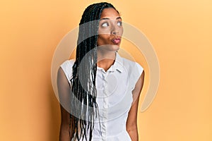 African american woman wearing casual clothes smiling looking to the side and staring away thinking