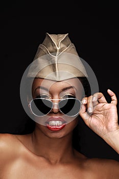 African American woman wearing a military cap and sunglasses with lots of attitude, Beauty model for cosmetic makeup treatments