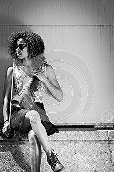 African American Woman wearing sunglasses and holding violin