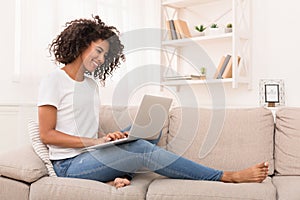 African-american woman working on laptop computer at home