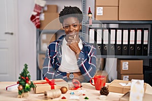 African american woman working at small business doing christmas decoration looking confident at the camera with smile with