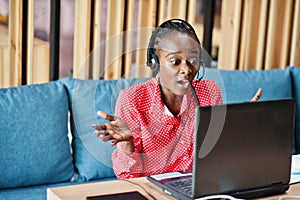 African american woman works in a call center operator and customer service agent wearing microphone headsets working on laptop