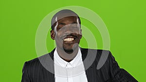 African american wonderful guy, his smile conquers all, and laughter is contagious. Green screen. Close up