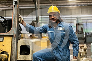 African american worker man wear safety helmet driver forklift warehouse in factory. Male worker industrial operate. control