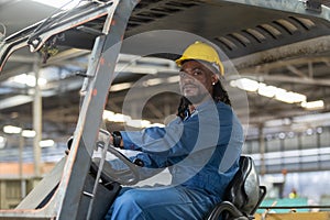 African american worker man wear safety helmet driver forklift warehouse in factory. Male worker industrial operate. control
