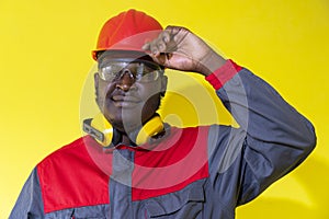 African American Worker In Protective Workwear Against Yellow Background