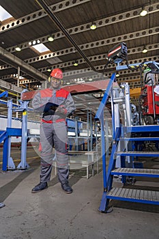 African American Worker In Protective Workwear With Clipboard Looking At Camera